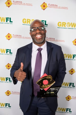 PVM CEO Pat Mack holding GrowFL award